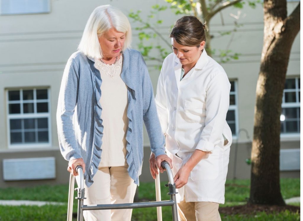 Care Taker Helping Senior Walk