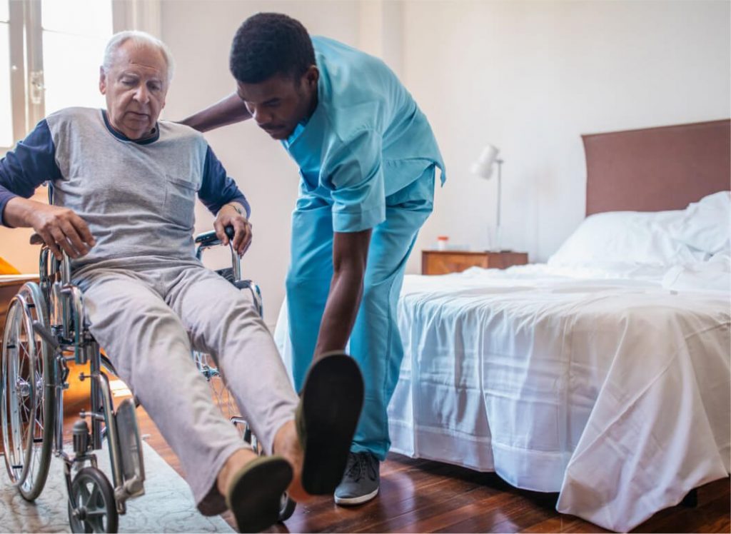 Healthcare worker helping senior on wheelchair